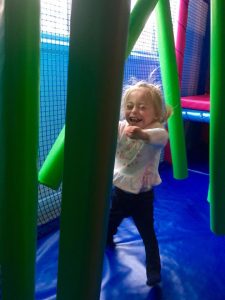 Little girl playing in the soft play area
