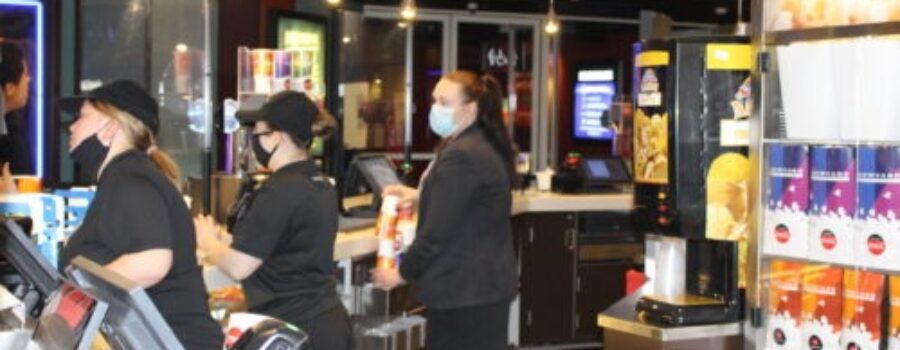 Showcase Cinema staff serving popcorn