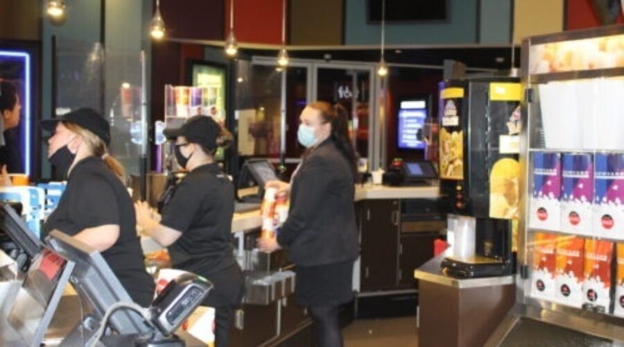 Showcase Cinema staff serving popcorn