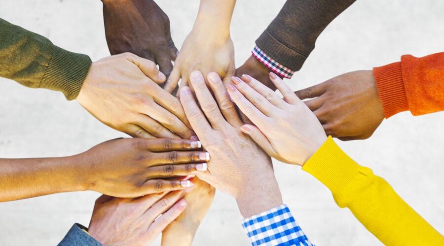 Many hands holding each other
